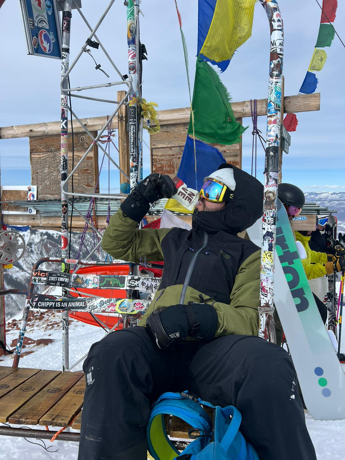 Aspen skier at Highlands Bowl enjoying Tart Cherry Cacao Neve as a ski snack