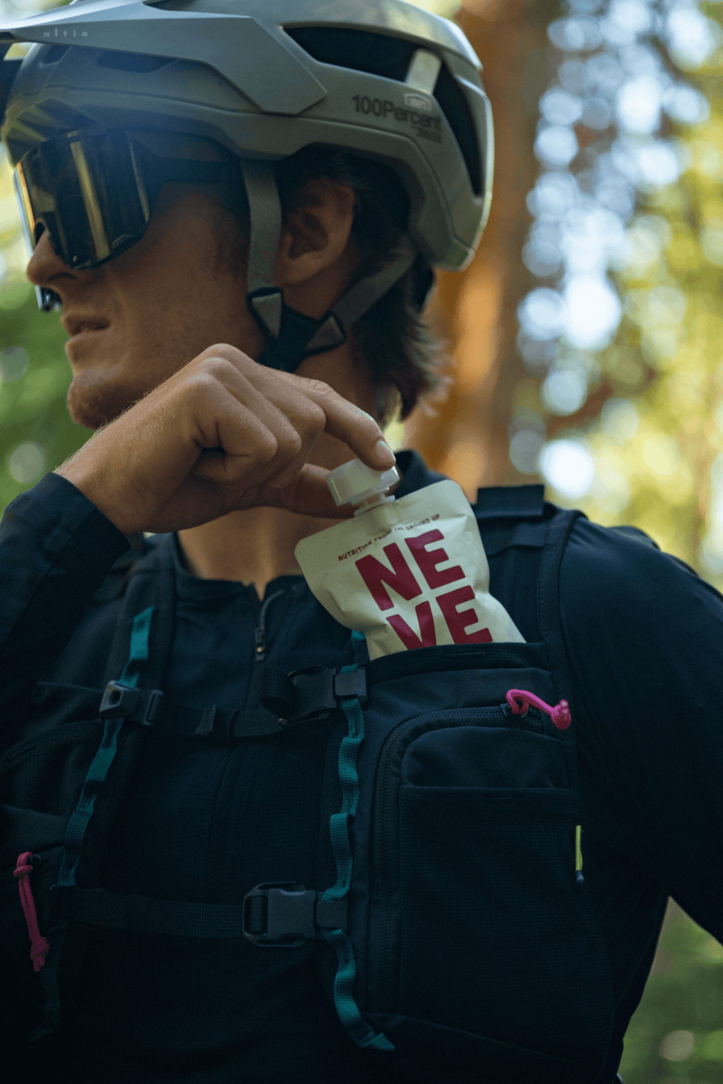 Mountain biker grabs boysenberry beet smoothie pouch from pack
