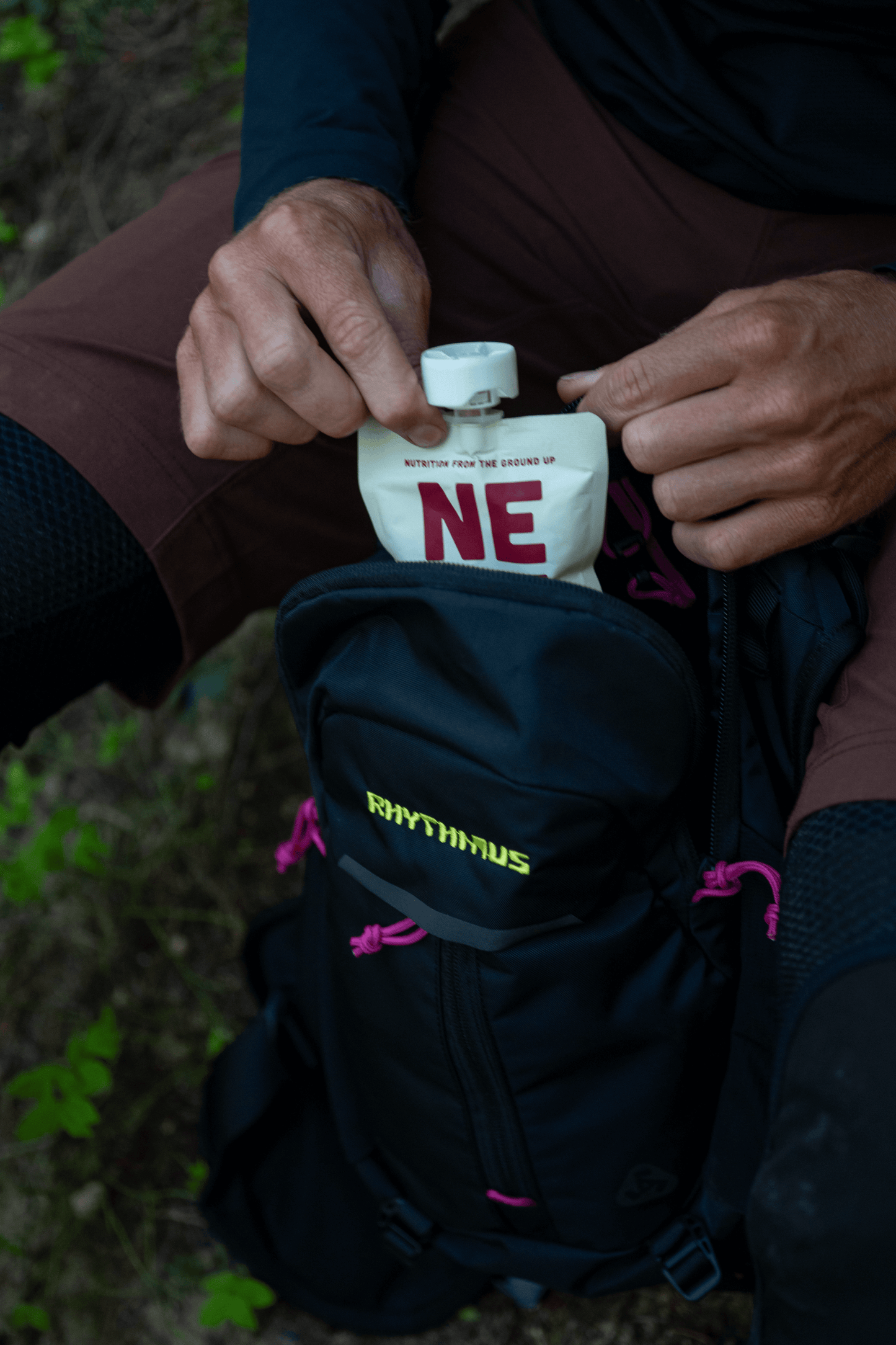 Mountain biker grabs boysenberry beet smoothie pouch from pack