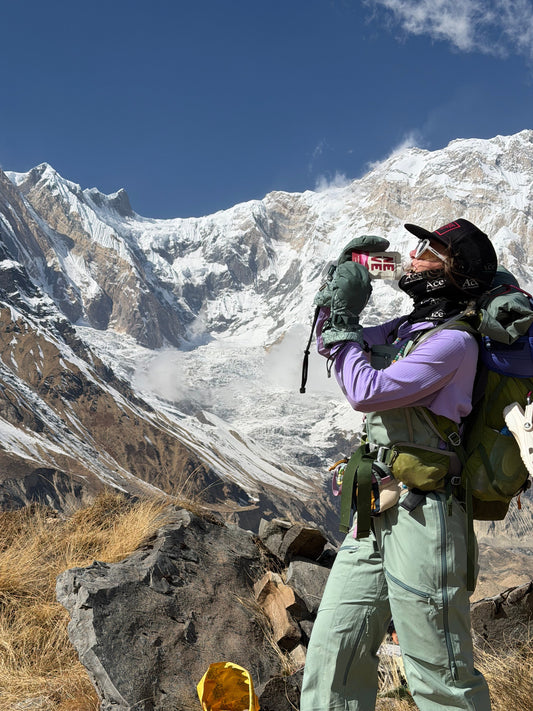 Athlete uses Neve Boysenberry Beet Smoothie Pouch while trekking in Nepal.