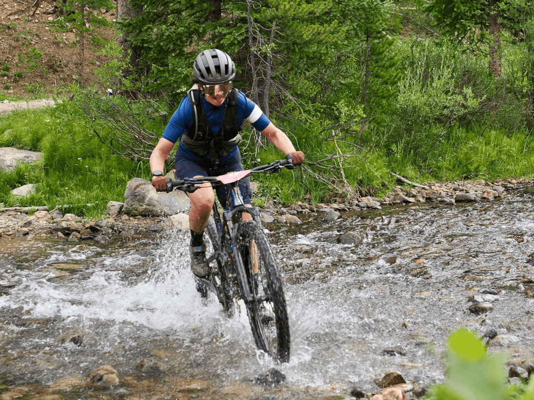 Nora crossing a river during The Breck Epic